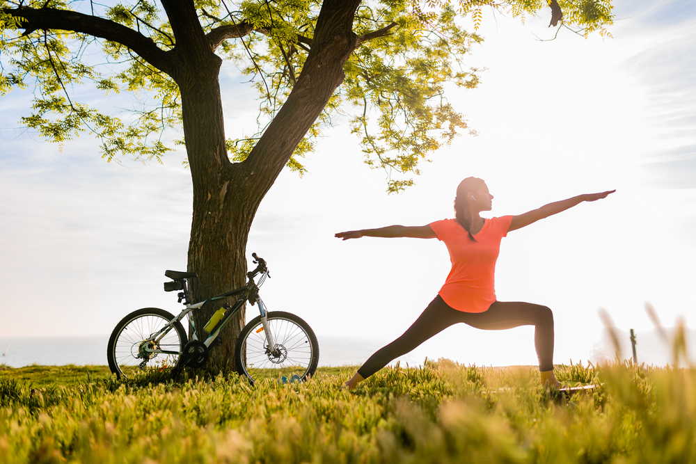 slim beautiful woman silhouette doing sports morning park doing yoga 1