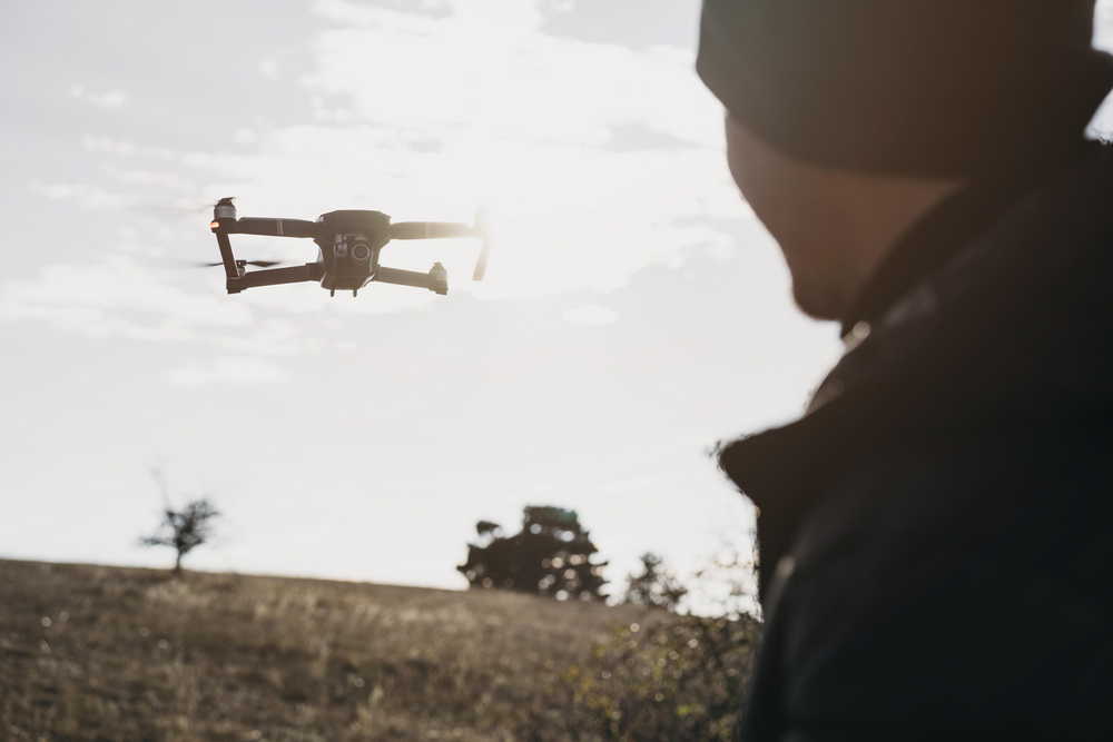 close up man watching drone