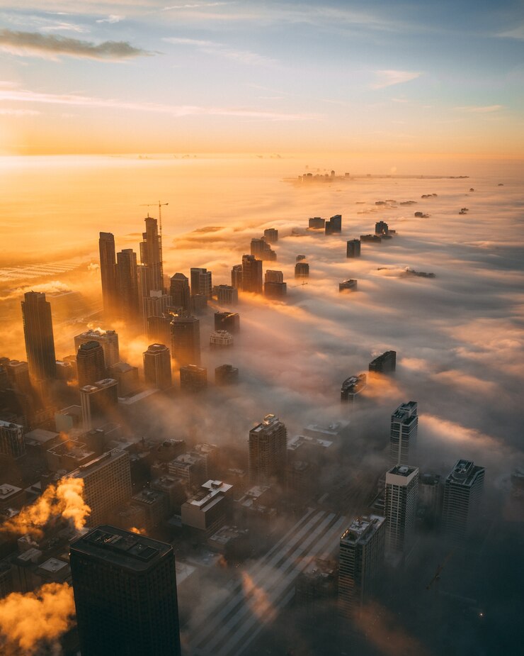high angle shot cityscape with tall skyscrapers sunset covered with white clouds 181624 23015