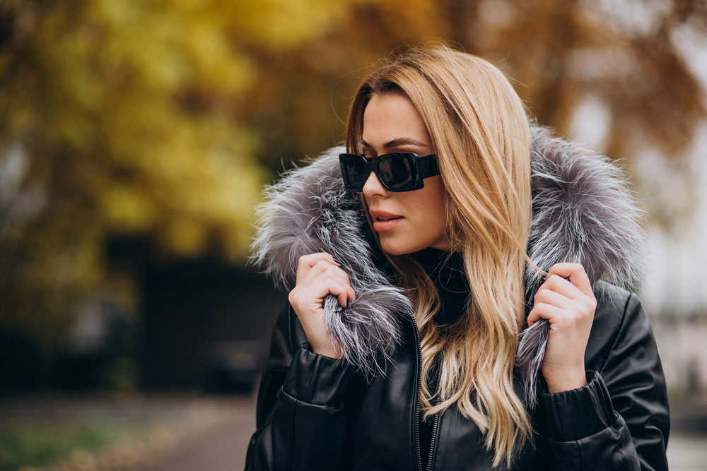 young woman wearing jacket walking outside