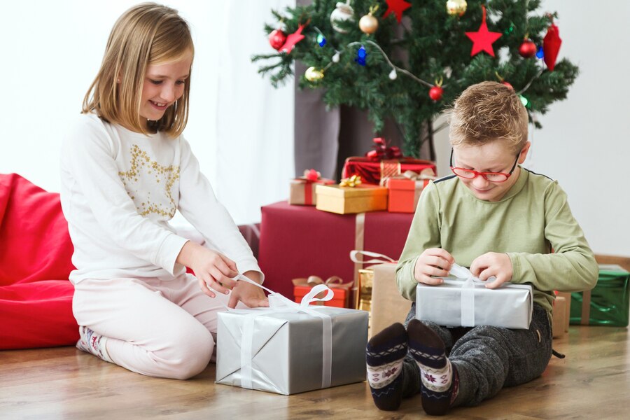 children opening christmas presents floor 23 2147580794