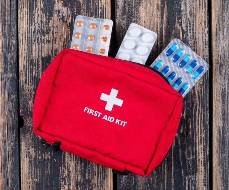 first aid kit with pills top view dark wooden background 176474 1696