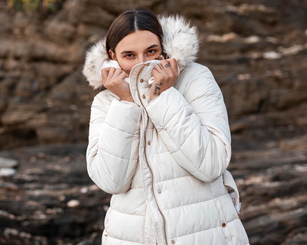 woman alone beach with winter jacket 23 2148801507