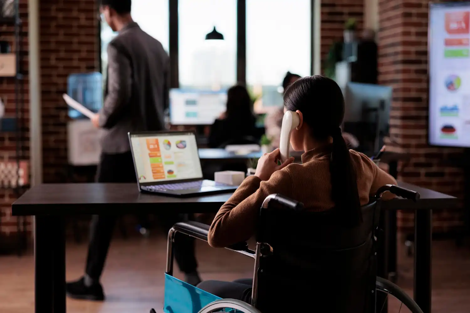 company worker with physical impairment talking landline phone having remote conversation office telephone wheelchair user with chronic health condition chatting phone call