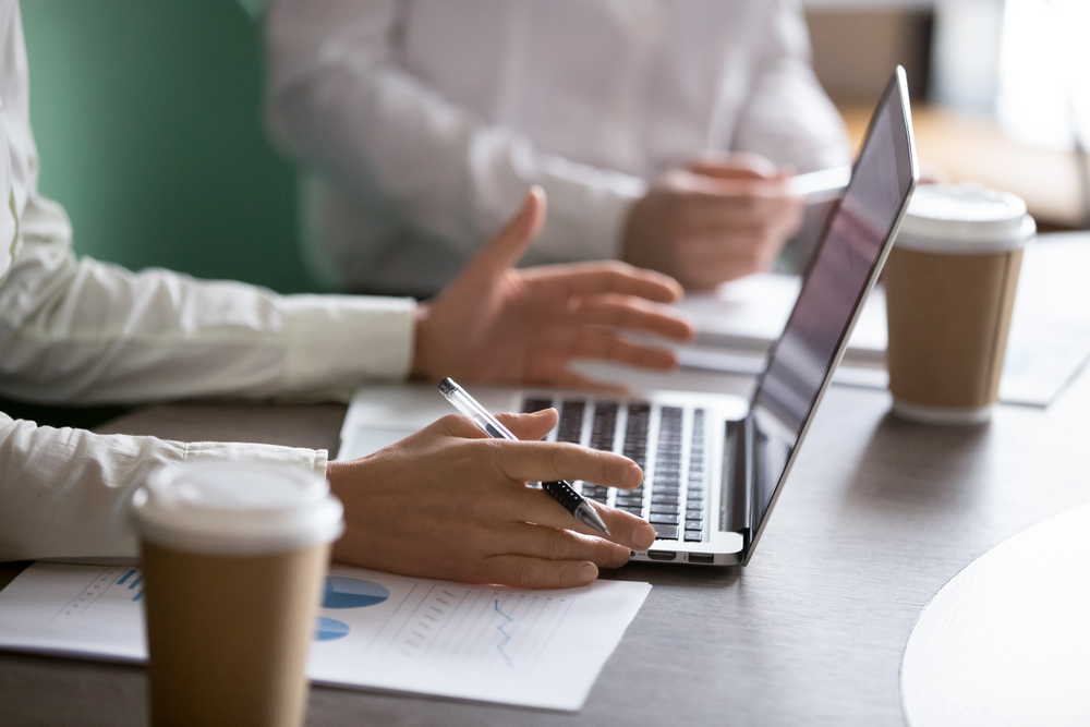 businesswoman using laptop presenting project report business meeting closeup