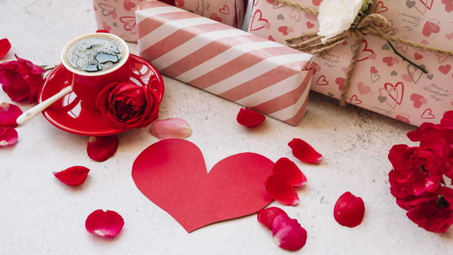 gift boxes wrap near flower petals paper heart cup with drink