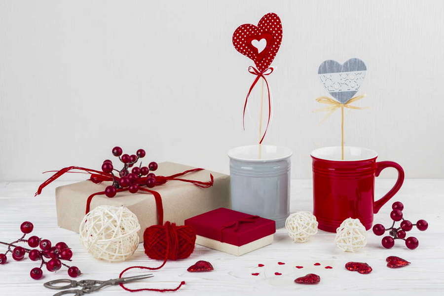 mugs with hearts wands near little hearts scissors presents