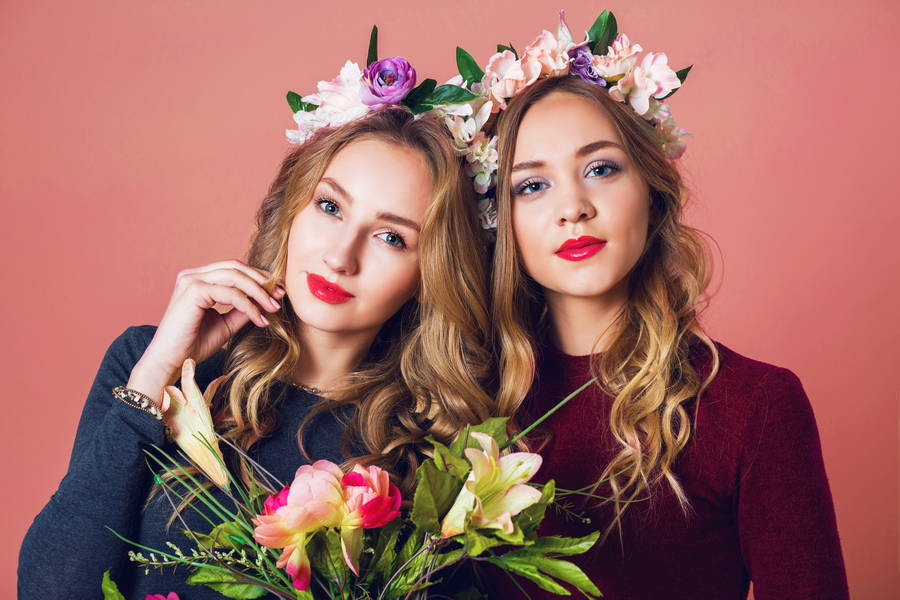 close up studio portrait two young pretty blonde women spring flowers wrath amazing wavy long hairstyle bright make up looking camera 1