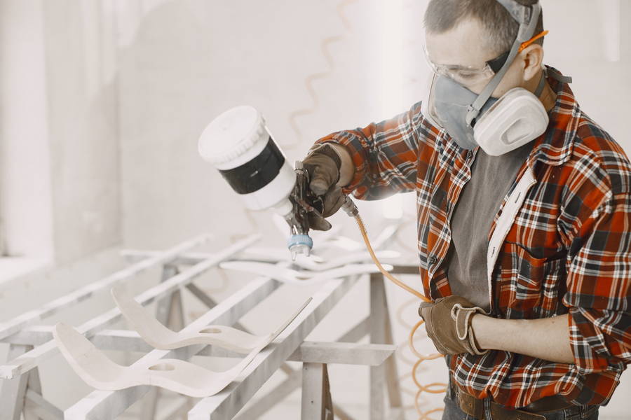 master painter factory painting wood with spray gun