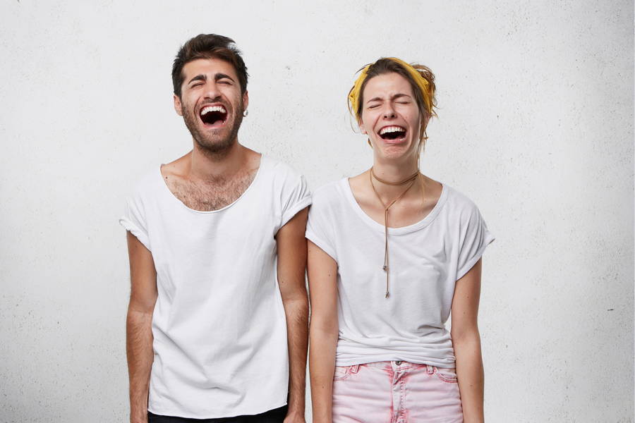 people facial expressions body language concept young female her boyfriend laughing with widely opened mouth closed eyes